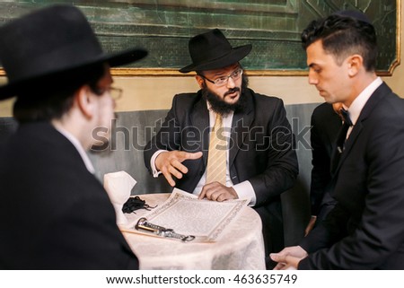 Jews talk about something while sitting at the table