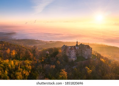 Jezeri Castle During November’s Foggy And Sunny Morning. Autumn Colorful Landscape From Above. Fog Cover Huge Czechoslovak Army Coal Mine.