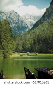 JEZERSKO, SLOVENIA - CIRCA JUNE 2016 Green lake and mountains in the background. It's a sunny summer day. 