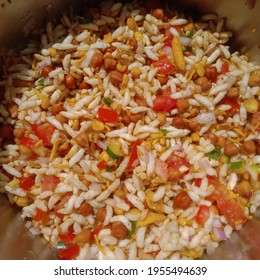 jhalmuri a street snack of India made of puffed rice gram tomato chilli and onion slices and mixture 