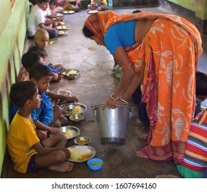 Jhargram, West Bengal, India - December 13, 2019: Mid Day Meal Program, An Indian Government Initiative, Is Being Running In A Primary School. Pupils Are Taking Their Meal.