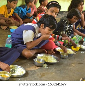 Jhargram, West Bengal, India - December 13, 2019: Mid Day Meal Program, An Indian Government Initiative, Is Being Running In A Primary School. Pupils Are Taking Their Meal.