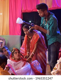 Jhargram, West Bengal, India - March 9, 2021: Indian Wedding Photographer In Action, Taking A Picture Of The Indian Bride And Groom.