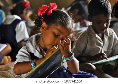 Jharkhand, India. 19 March,2020 - Unidentified group of  children friends classmates in government school uniforms sitting on floor, studying.