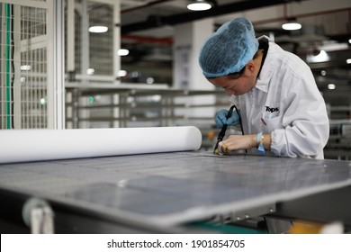 Jiangxi, China - Jan 5, 2021: Workers Operate Equipment To Produce Photovoltaic Circuit Boards At A Production Workshop Of A Green Energy Technology Company In Jiujiang, Jiangxi Province.