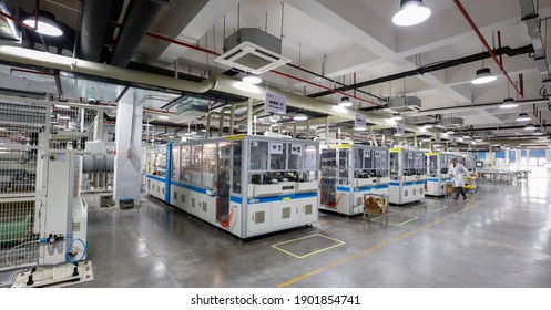 Jiangxi, China - Jan 5, 2021: Workers Operate Equipment To Produce Photovoltaic Circuit Boards At A Production Workshop Of A Green Energy Technology Company In Jiujiang, Jiangxi Province.