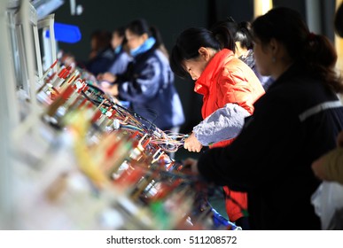 JIANGXI CHINA-December 9, 2011:Jiujiang, Jiangxi, An Electronics Company Factory Workers In The Production Of Automotive Circuit System Equipment.