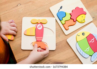  Jigsaw Baby Early Educational Toys 3D Puzzle Children Ability Exercise Kids Wooden Gifts. Boy hand on puzzle part. Early education, focus exercises