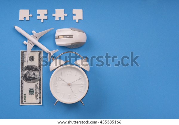 jigsaw, money,\
clock, airplane model  and computer mouse on blue background,\
Balance working\
concept.