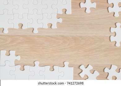 Jigsaw puzzle game piece on light cream brown wood table background for business startup solution and analytical problem solving concept