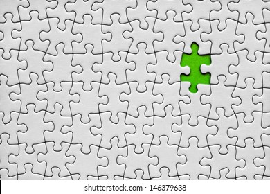 Jigsaw puzzle with one green piece missing