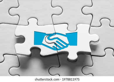 Jigsaw Puzzle Piece With Handshake Icon. Business Agreement, Consensus, Strategic Alliance Or Partnership Concept.