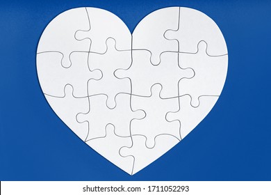 Jigsaw Puzzle Pieces In Form Of Heart On Blue Background. Love, Charity, Donation, Helping Concept. Perfect Match, Reunion.