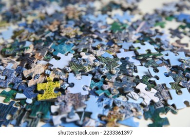 Jigsaw puzzle pieces on table, closeup view - Shutterstock ID 2233361397
