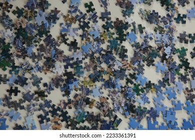 Jigsaw puzzle pieces on white table, flat lay - Shutterstock ID 2233361391