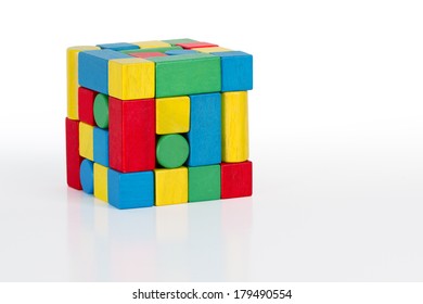 jigsaw puzzle rubik cube toy, multicolor wooden pieces, colorful game bricks over white background 