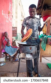 Jinja, Uganda - September 30, 2016: Man Cooking Omelette With Tomato And Onion, Local Dish Called Rolex 