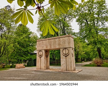 Târgu Jiu, RO - April 28, 2021: Gate of the Kiss (Poarta Sărutului) by Constantin Brâncuși and Alley of Chairs. Springtime view of the sculptural ensemble. Beautiful UNESCO world heritage monuments.