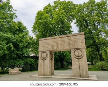 Târgu Jiu, RO - May 7, 2021: Gate of the Kiss (Poarta Sărutului) and Alley of the Chairs (Aleea Scaunelor) by Constantin Brancusi Sculptural Ensemble. European patrimony monument site in springtime.