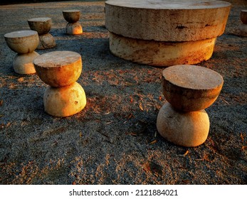 Târgu Jiu, RO - November 9, 2020: Table of Silence (Masa Tăcerii) monument by Romanian sculptor Constantin Brancusi. Artistic side view at sunset of the hourglass shaped chairs surrounding the table.