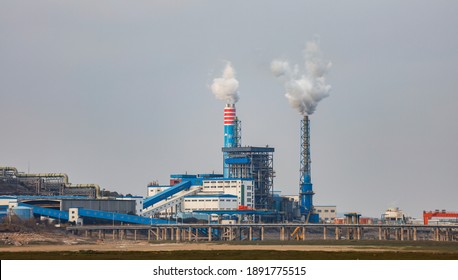 Jiujiang, China - Jan10, 2021: Smoky Smokestacks At A Chemical Plant On The Banks Of Poyang Lake. China's Carbon Emission Trading System (a National Carbon Market) Has Been Put Into Operation.