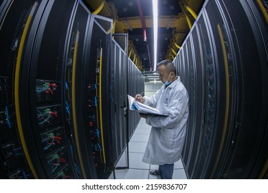 Jiujiang, China - May 21, 2022: An IDC inspection engineer checks the server operation in the machine room of China Telecom's Central Cloud Computing Big Data Center.Cooperate with alibaba, JD, Inspur