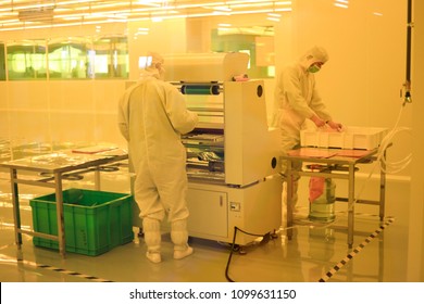 JIUJIANG CHINA-April 19, 2018: high technology R & D personnel are developing high precision circuit boards on a modern machine tool of an electronics company. The scene is ambient light.