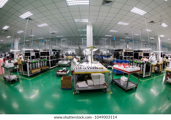 JIUJIANG\
CHINA-March 16, 2018:The export processing zone in the eastern city\
of Jiujiang, Jiangxi SONIRD Polytron Technologies Inc automation\
workshop, workers are making photovoltaic\
power