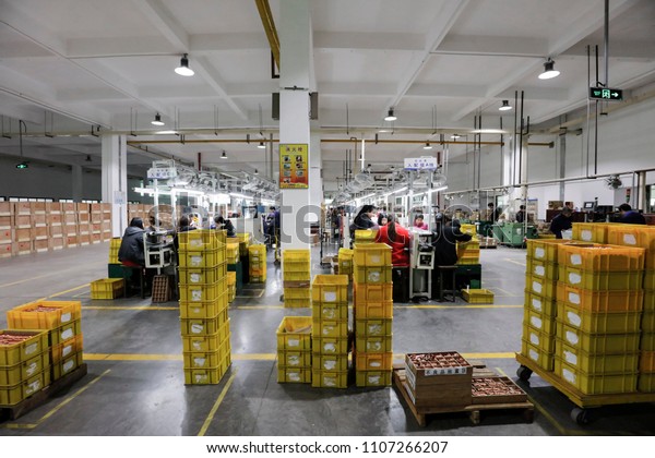 JIUJIANG CHINA-March 30, 2018: female workers\
operate machines in the workshop to produce motor parts, such as\
small motors, which are invested in sweatshops in Jiujiang,\
Jiangxi, Eastern\
China.