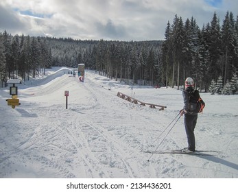 JIZERA MOUNTAINS, CZECH - REPUBLIC, FEBRUARY 26, 2022:  people cross-country skiing in the snowy mountains on a sunny day