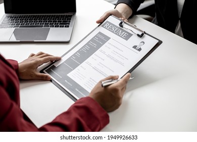 The job applicant is submitting a resume to the manager for a job interview. The concept of a job interview in a position that matches the candidate's qualifications and abilities. - Shutterstock ID 1949926633