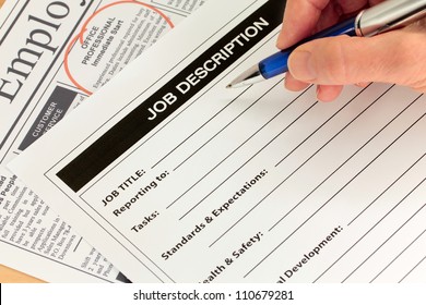 Job Description with Hand and Pen and Newspaper Ad - Shutterstock ID 110679281