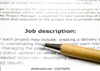 Job description with wooden pen - Shutterstock ID 1226756296