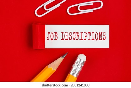JOB DESCRIPTIONS message written under torn red paper with pencils and clips, business - Shutterstock ID 2031241883