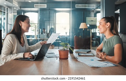 Job interview for a business woman at a hiring company talking to the HR manager about the role or position. Young female applicant or candidate in a meeting with an employer having a discussion