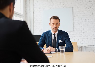 Job interview - businessman listen to candidate answers