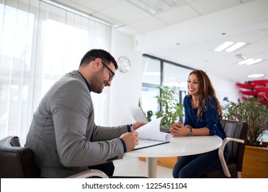 Job interview. Employer reading CV while candidate is smiling. Successful candidate selection for employment.