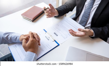 Job Interview and hiring concept, Appointment candidate Business man explaining about his profile and answer to Human resources manager sitting at a table opposite in the office