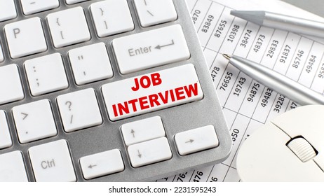 JOB INTERVIEW text on keyboard wirh chart and pencil - Shutterstock ID 2231595243