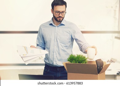 Job Loss - Fired Man Putting His Belongings In Cardboard Box