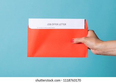 Job Offer - A Letter About The Successful Completion Of Job Search. A Woman's Hand Is Holding A Red Letter With CV.