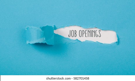 Job Openings Message On Torn Blue Paper Revealing Secret Behind Ripped Opening.