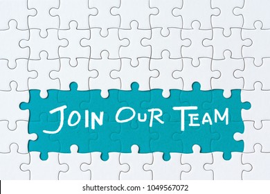 Job recruiting advertisement represented by 'JOIN OUR TEAM' texts on the jigsaw puzzle board. Rows of jigsaw pieces are removed appealing blue green background - metaphor to represent hiring positions - Shutterstock ID 1049567072