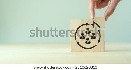 Job rotation management concept. Forecasting future staffing needs, analyzing current staffing levels and developing human resource strategies. Wooden blocks with manpower or staffs icons.

