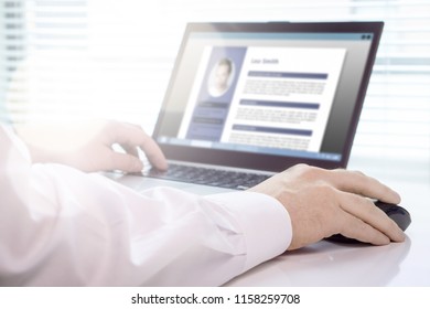 Job seeker and applicant writing his resume and CV with laptop. Modern and visual electronic curriculum vitae in social media. Work experience document in computer screen. Job search and unemployment.
