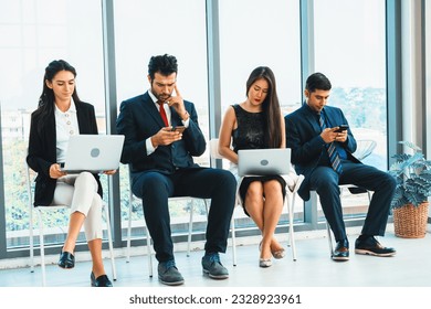 Job seekers and applicants waiting for interview on chairs in office. Job application and recruitment interview qualification concept. Jivy - Shutterstock ID 2328923961