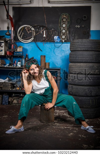 Job in the\
service station. The girl in the mask working at the bench. Hard\
work for women.  Master welder, Working profession. Where to go to\
study. Work without higher\
education