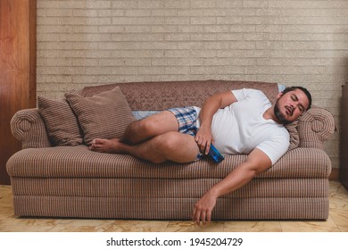 A Jobless And Lazy Couch Potato Naps Sprawled Out On The Sofa Still Holding His Phone.