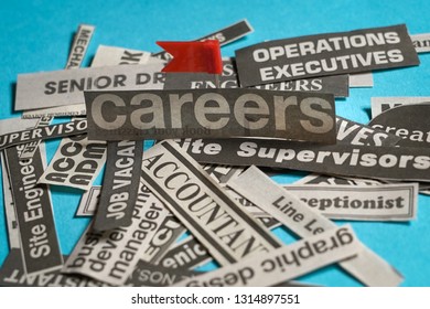 Jobs Or Careers Concept: Multiple Job Titles Or Occupations Cut Off From Newspaper With Careers At The Centre Of The Pile, Blue Background