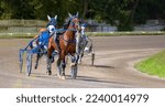 Jockeys and horses. Racing horses competing with each other. Race in harness with a sulky or racing bike. Harness racing. Trotting horse race. Sport banner